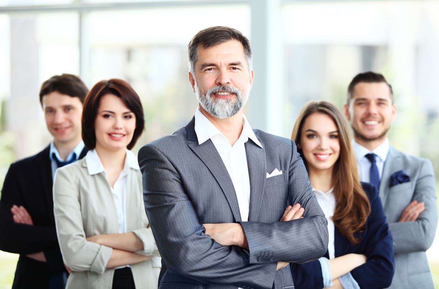 New – Business Professionals Smiling – Senior Exec in front | BlueSky Solutions Group LLC
